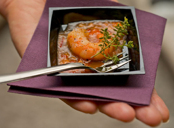 Cocktail napkin in customer's hand with food